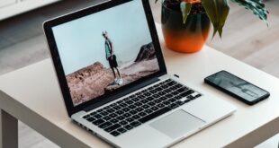 macbook on white table